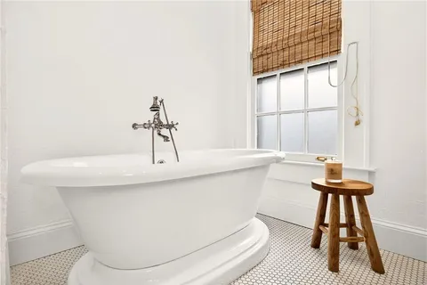 a balcony with outdoor seating and wooden floor