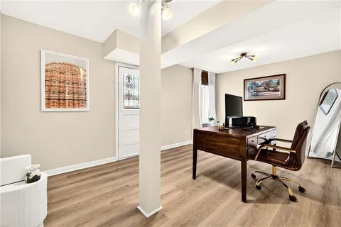 a view of a patio with couches and table and chairs and potted plants