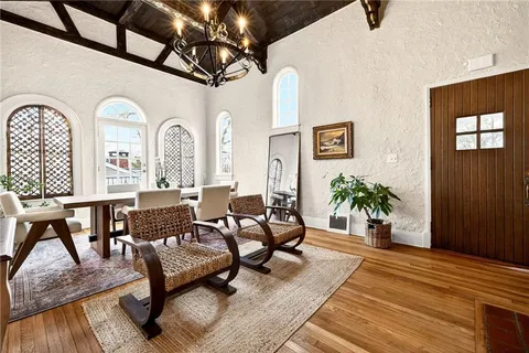 a view of a dining room with furniture and a large window