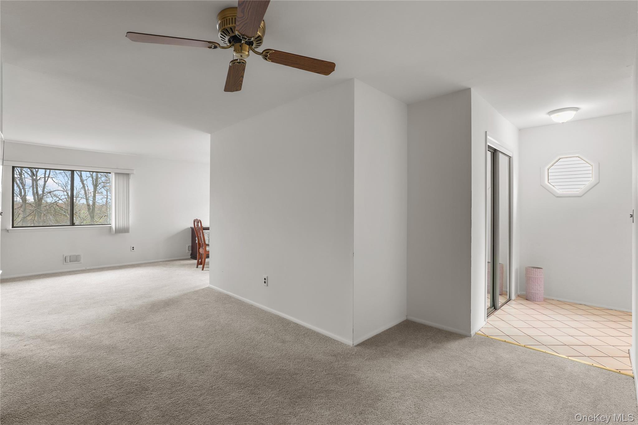 116 Village Road, Unit D Yorktown Heights, NY 10598 - Photo 16 of 32 an empty room with windows and fan