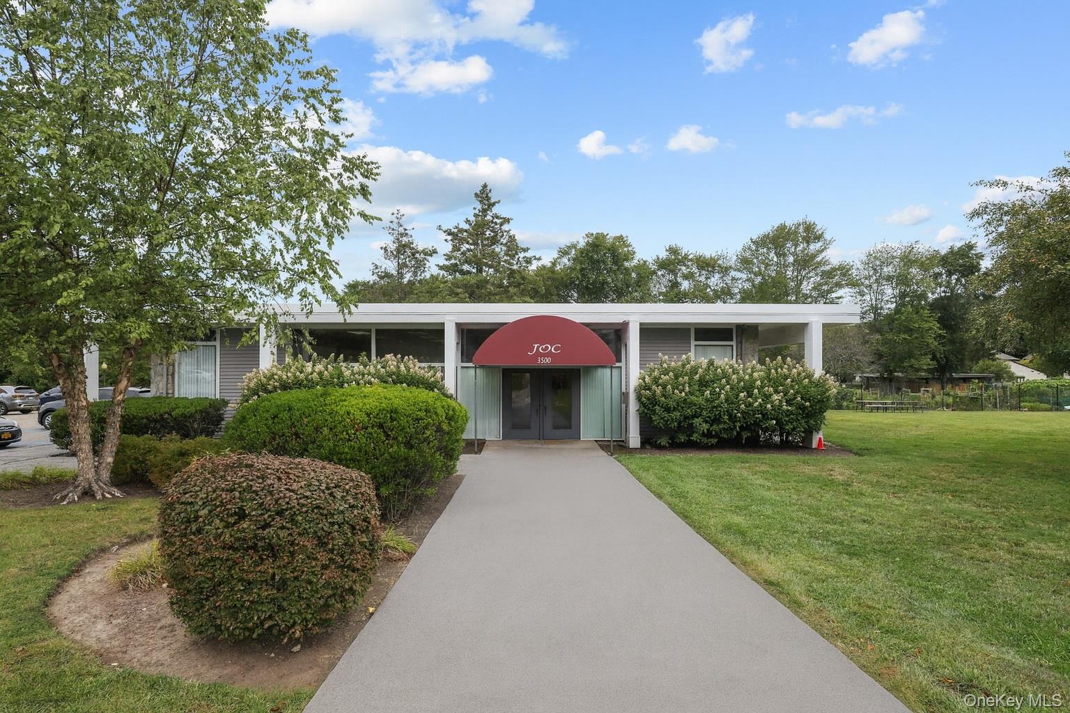116 Village Road, Unit D Yorktown Heights, NY 10598 - Photo 32 of 32 a view of a house with a garden