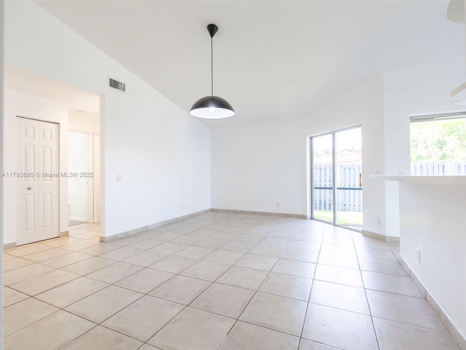 1225 Seagrape Circle Weston, FL 33326 - Photo 13 of 61 a view of an empty room and window