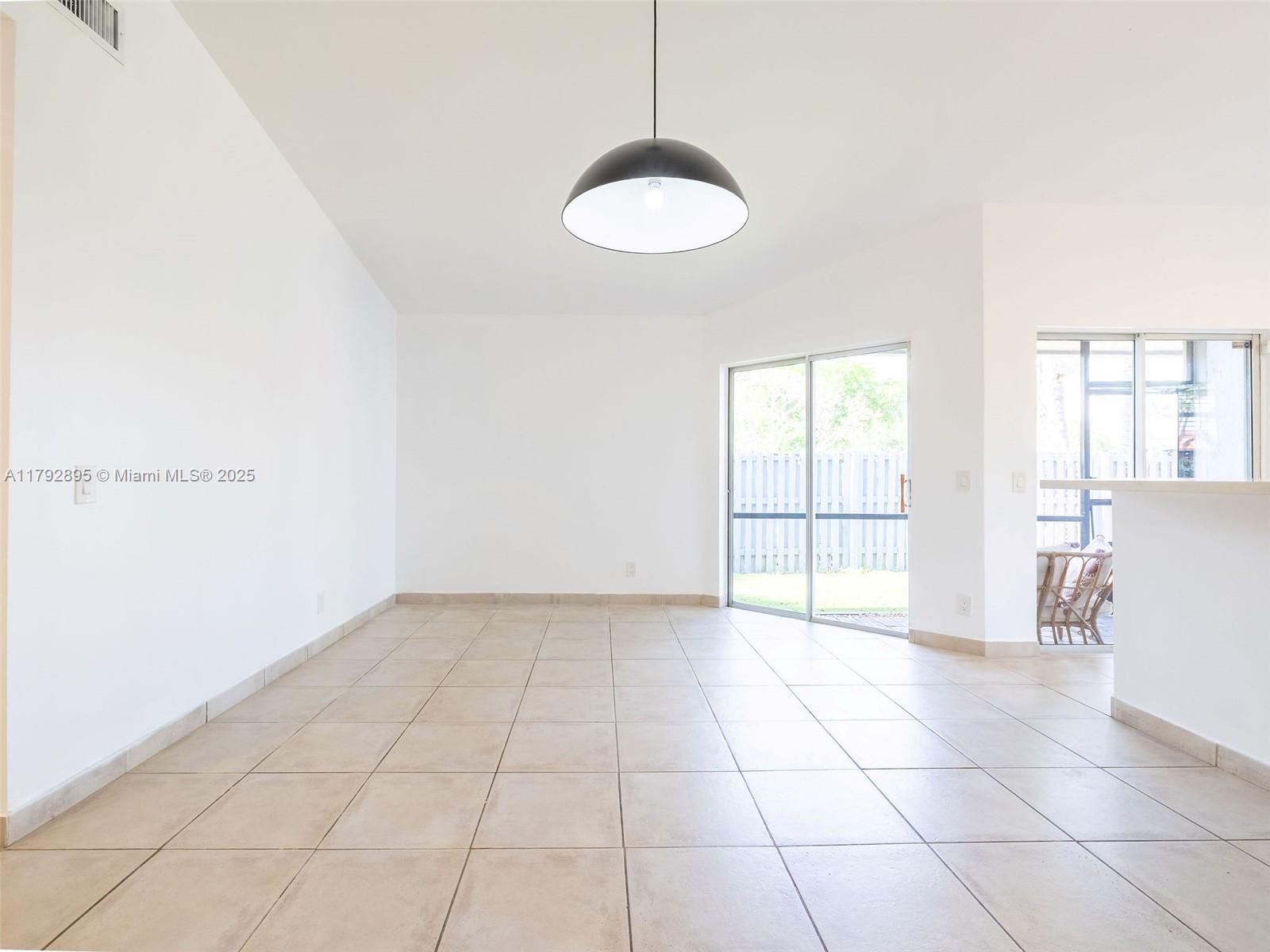1225 Seagrape Circle Weston, FL 33326 - Photo 16 of 61 a view of an empty room with a window