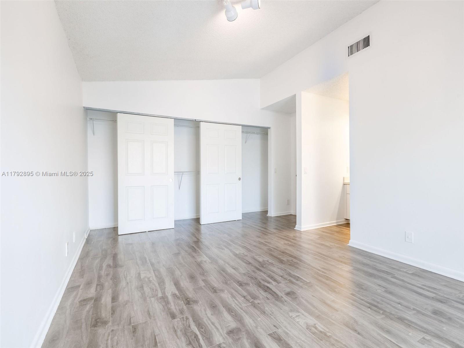 1225 Seagrape Circle Weston, FL 33326 - Photo 18 of 61 a view of an empty room with wooden floor