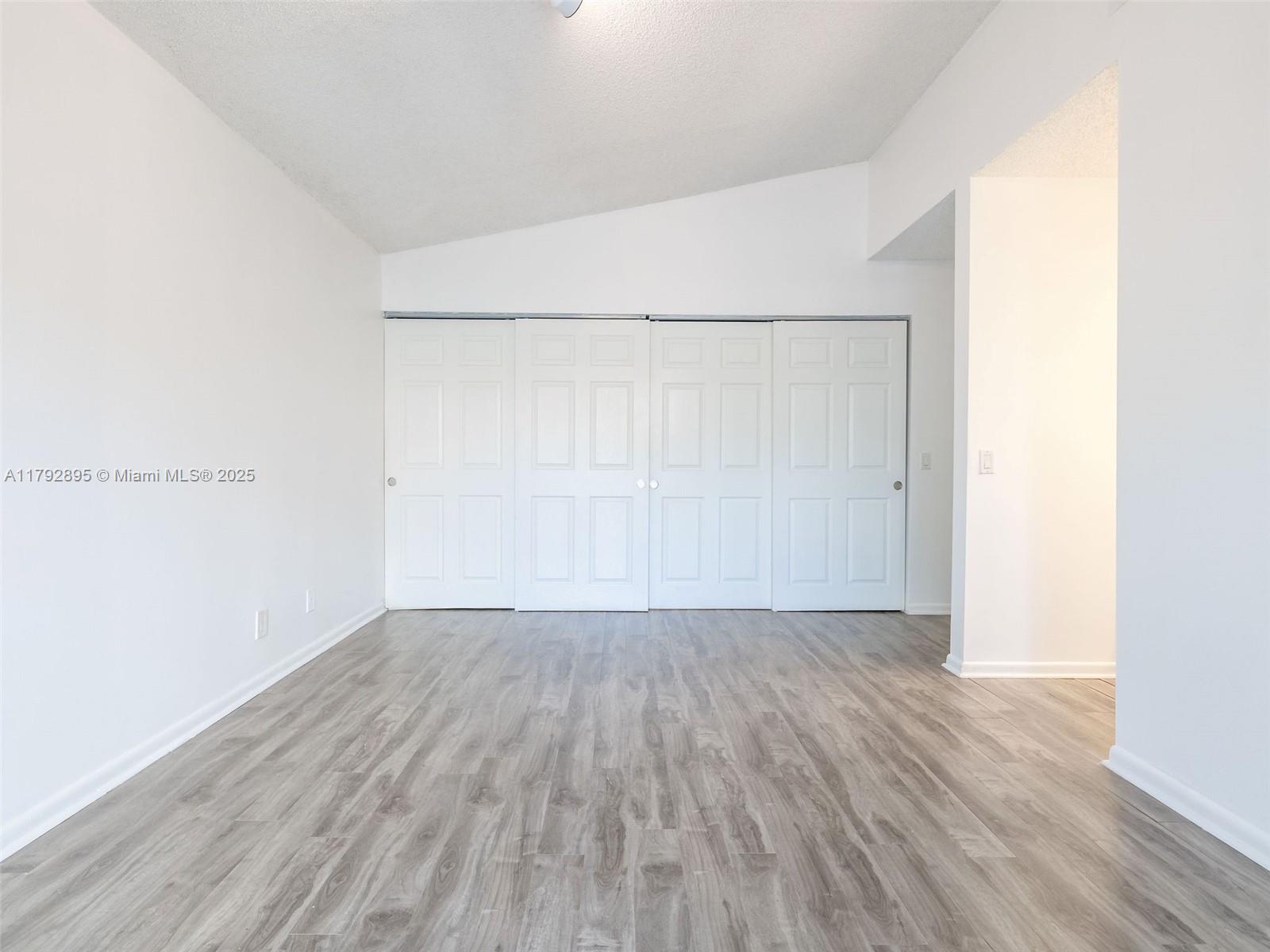 1225 Seagrape Circle Weston, FL 33326 - Photo 21 of 61 a view of an empty room with wooden floor