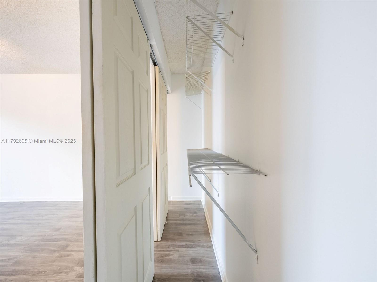 1225 Seagrape Circle Weston, FL 33326 - Photo 24 of 61 a view of a hallway with wooden floor and staircase
