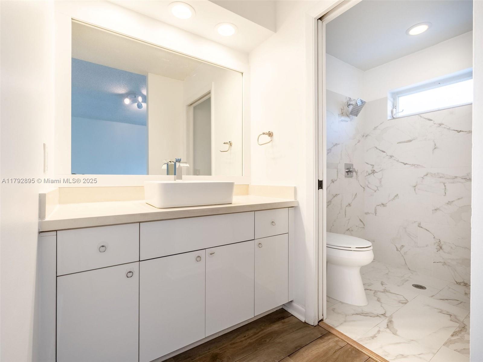 1225 Seagrape Circle Weston, FL 33326 - Photo 25 of 61 a bathroom with a sink toilet and shower