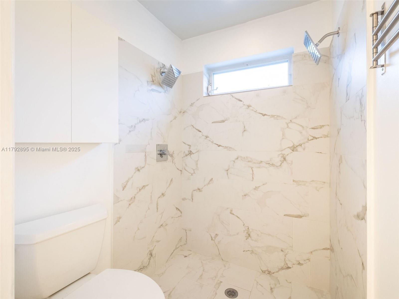 1225 Seagrape Circle Weston, FL 33326 - Photo 28 of 61 a bathroom with a bathtub and shower