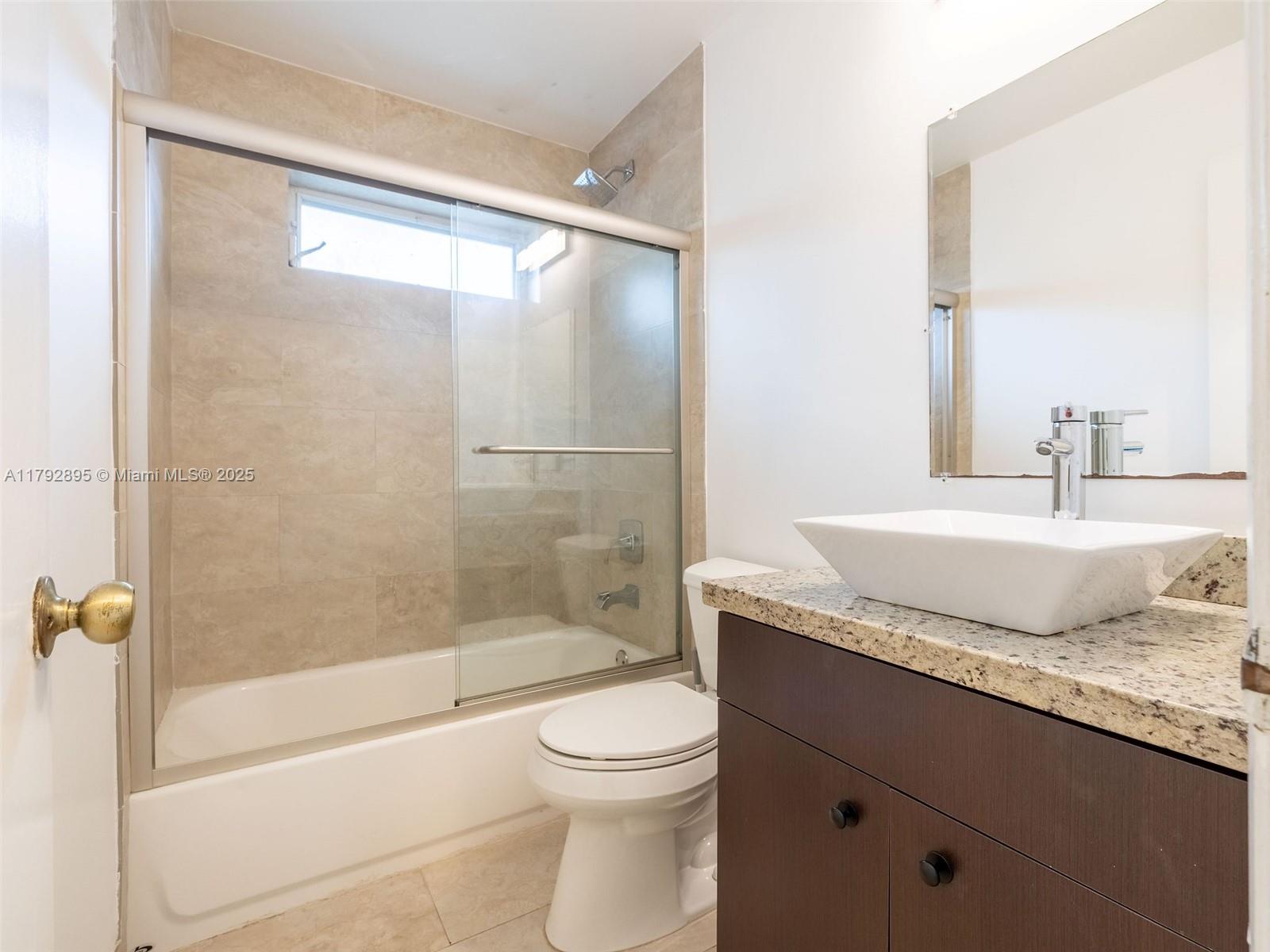 1225 Seagrape Circle Weston, FL 33326 - Photo 36 of 61 a bathroom with a granite countertop sink toilet and shower