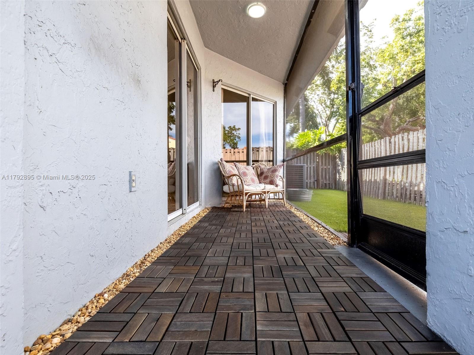 1225 Seagrape Circle Weston, FL 33326 - Photo 47 of 61 a view of a balcony with wooden floor