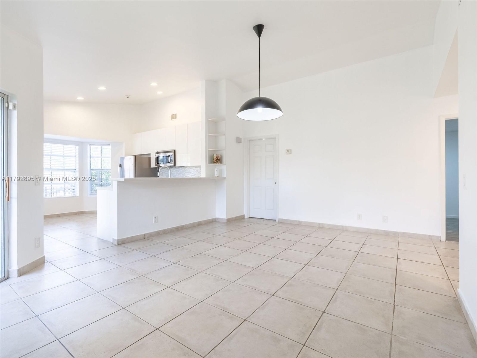 1225 Seagrape Circle Weston, FL 33326 - Photo 10 of 61 a view of a kitchen with a sink and a chandelier