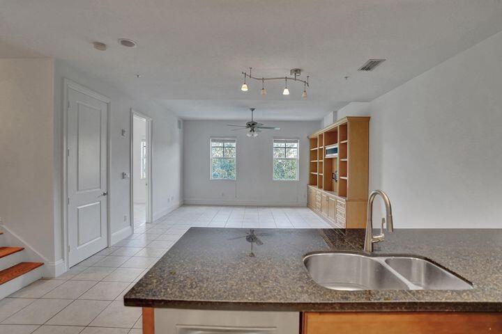 3120 East Latitude Circle, Unit 309 Delray Beach, FL 33483 - Photo 14 of 32 a view of kitchen sink microwave and window