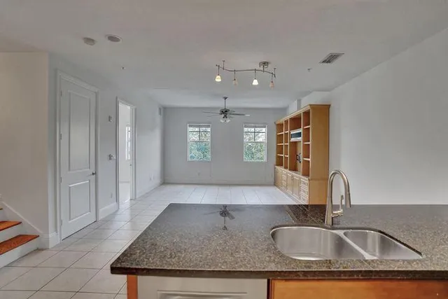 a view of kitchen sink microwave and window