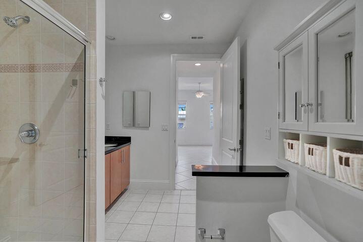 3120 East Latitude Circle, Unit 309 Delray Beach, FL 33483 - Photo 18 of 32 a kitchen with stainless steel appliances a refrigerator and cabinets