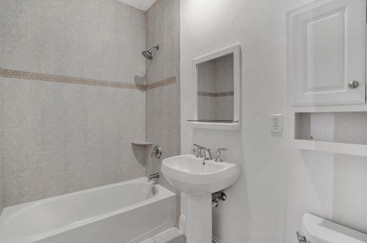 3120 East Latitude Circle, Unit 309 Delray Beach, FL 33483 - Photo 22 of 32 a white bath tub sitting next to a white sink