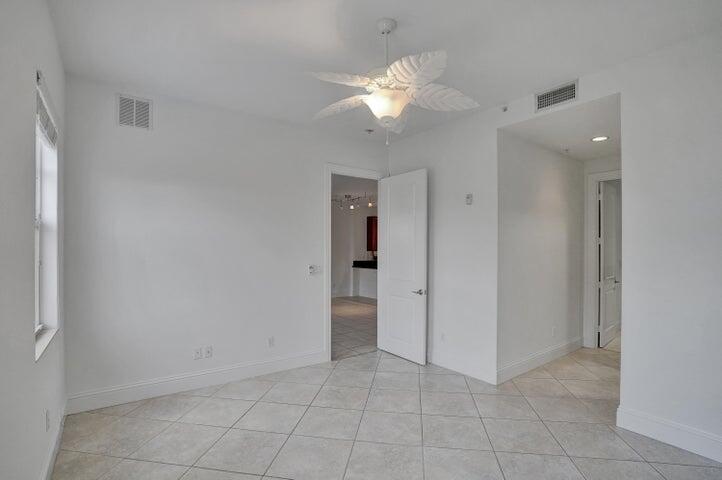 3120 East Latitude Circle, Unit 309 Delray Beach, FL 33483 - Photo 25 of 32 an empty room with fan and entrance