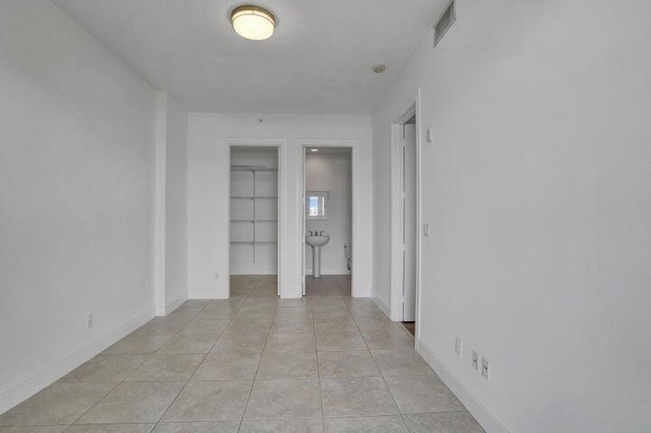 3120 East Latitude Circle, Unit 309 Delray Beach, FL 33483 - Photo 27 of 32 a view of a hallway with wooden shelves