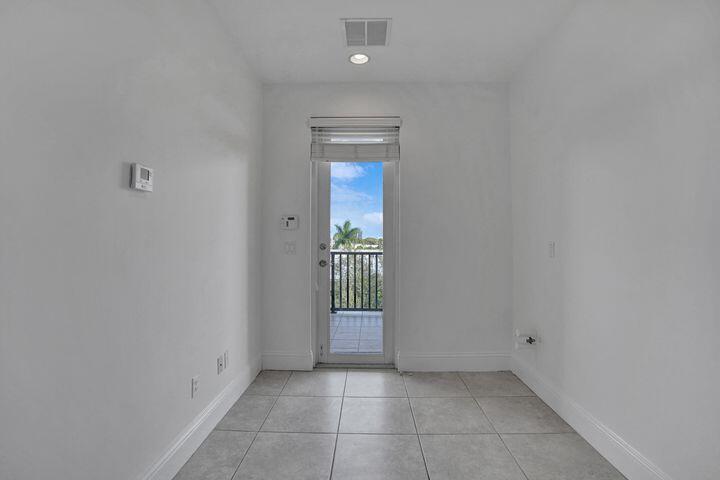 3120 East Latitude Circle, Unit 309 Delray Beach, FL 33483 - Photo 32 of 32 a view of an empty room with glass door
