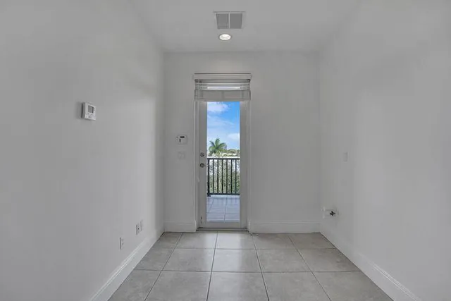 a view of an empty room with glass door