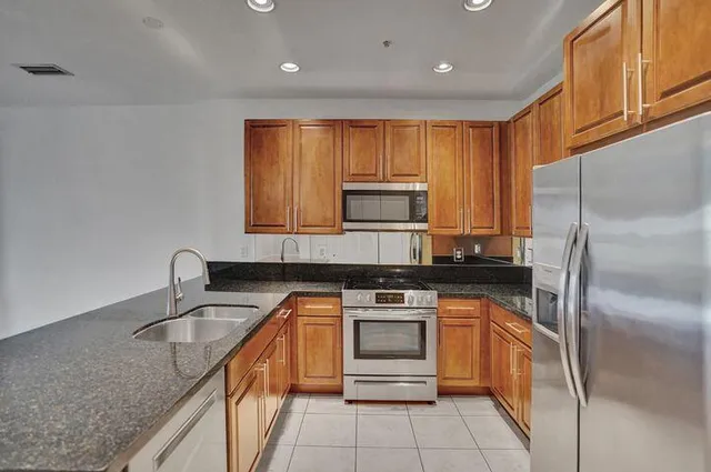 a kitchen with a sink stove and refrigerator