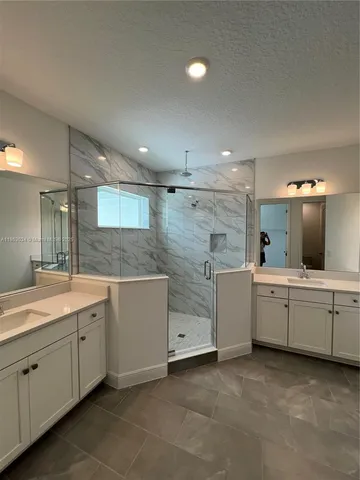 a large white kitchen with a sink