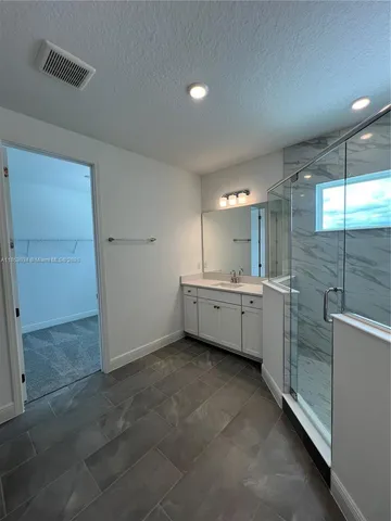 a bathroom with a double vanity sink and mirror