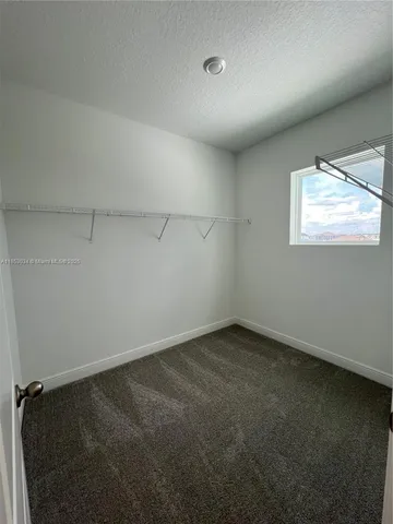 an empty room with a empty space and a window