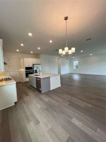 a view of kitchen with granite countertop cabinets and wooden floor
