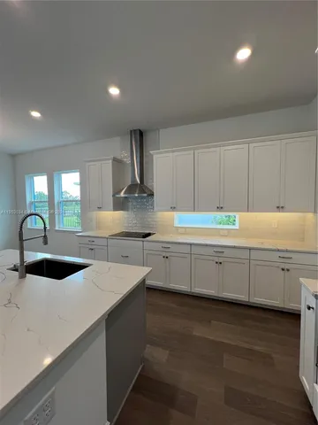 a kitchen with sink stove and cabinets