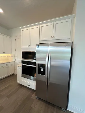 a kitchen with cabinets and stainless steel appliances