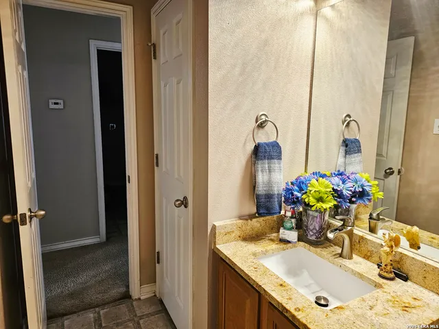 a bathroom with a sink vanity and a mirror
