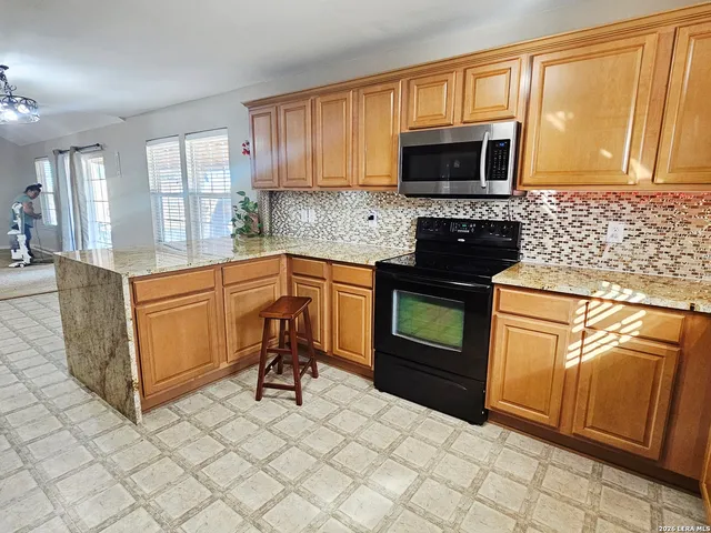 a kitchen with a stove microwave and sink