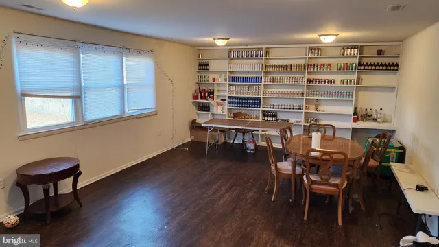 a view of a workspace with furniture and wooden floor
