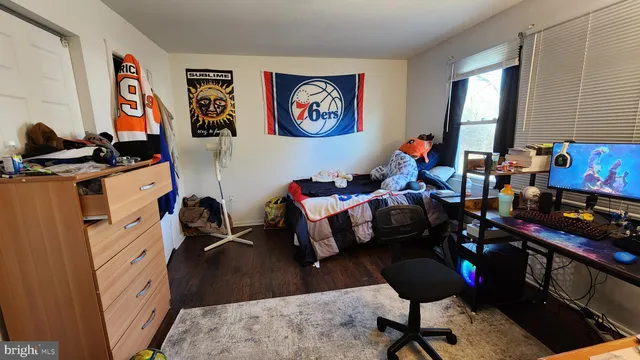 a bedroom with furniture and a window