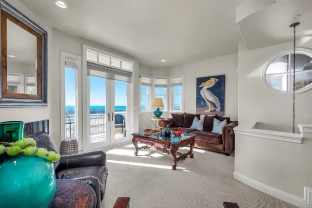 a living room with furniture and a floor to ceiling window
