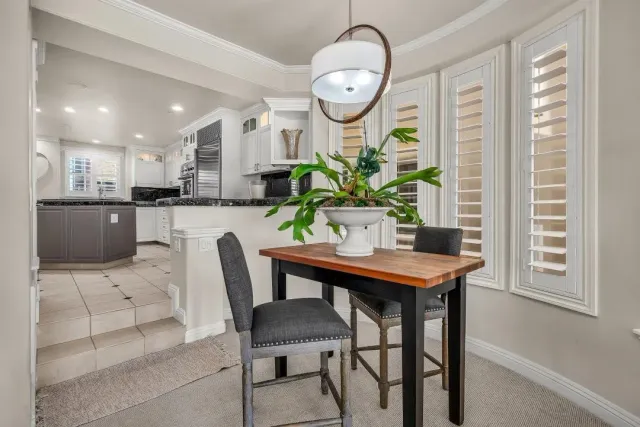 a view of a dining room with furniture and a chandelier
