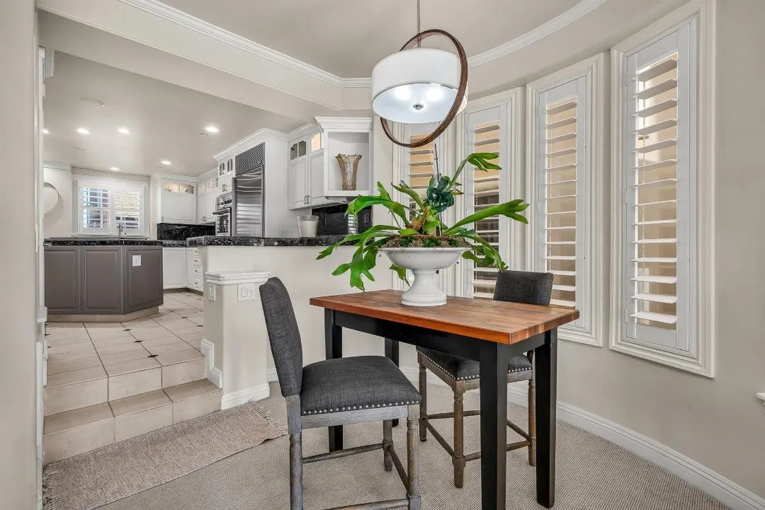 47 Surfside Avenue Surfside, CA 92649 - Photo 14 of 37 a view of a dining room with furniture and a chandelier