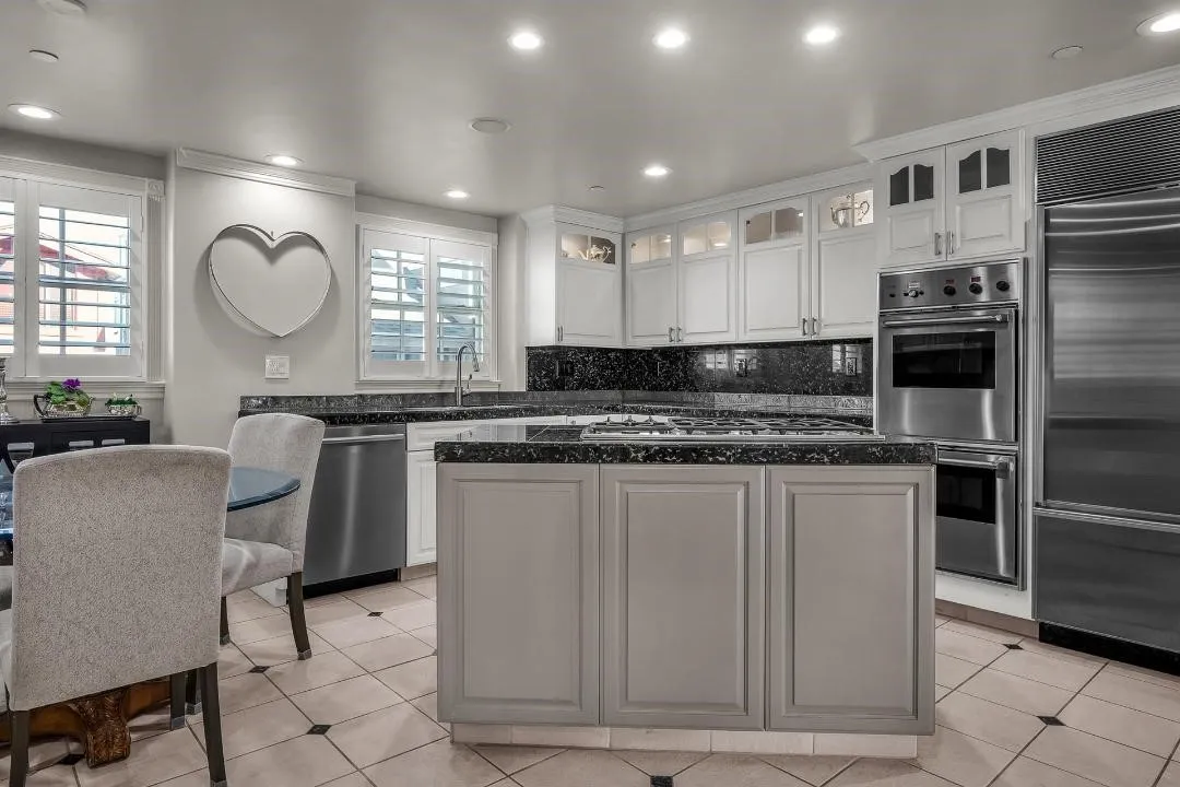 47 Surfside Avenue Surfside, CA 92649 - Photo 15 of 37 a kitchen with stainless steel appliances granite countertop a stove a sink and a refrigerator
