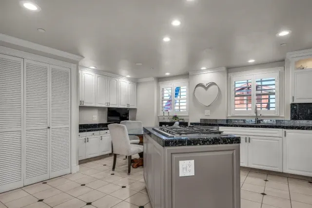 a kitchen with stainless steel appliances a stove a sink a stove a refrigerator and a microwave