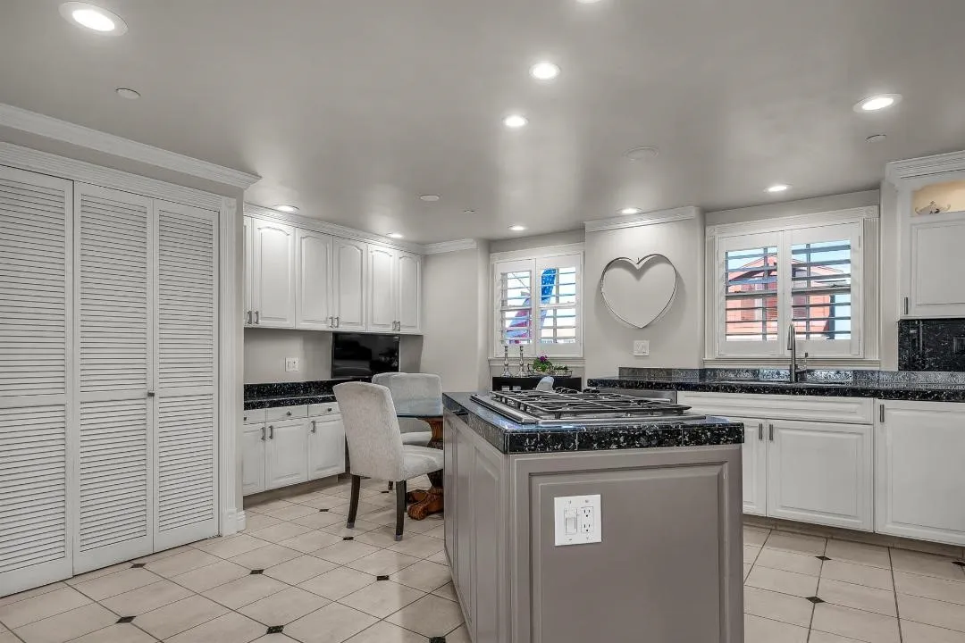 47 Surfside Avenue Surfside, CA 92649 - Photo 16 of 37 a kitchen with stainless steel appliances a stove a sink a stove a refrigerator and a microwave