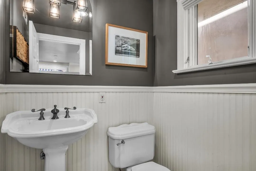 47 Surfside Avenue Surfside, CA 92649 - Photo 20 of 37 a bathroom with a toilet a sink and mirror