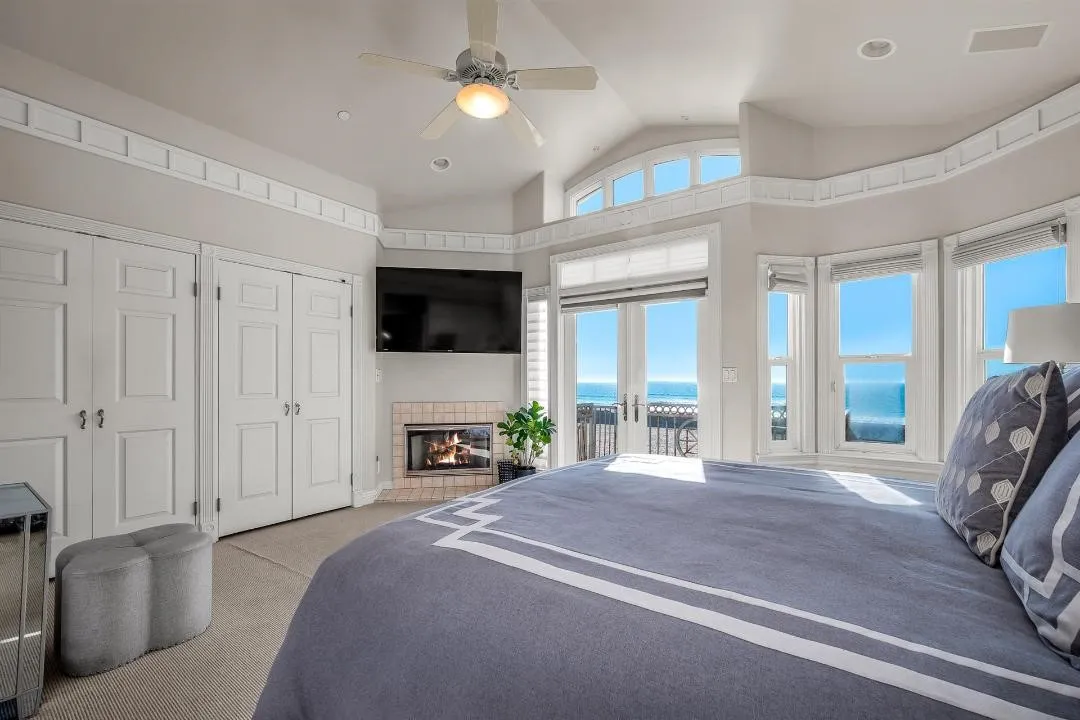 47 Surfside Avenue Surfside, CA 92649 - Photo 22 of 37 a spacious bedroom with a bed and a flat tv screen on dresser
