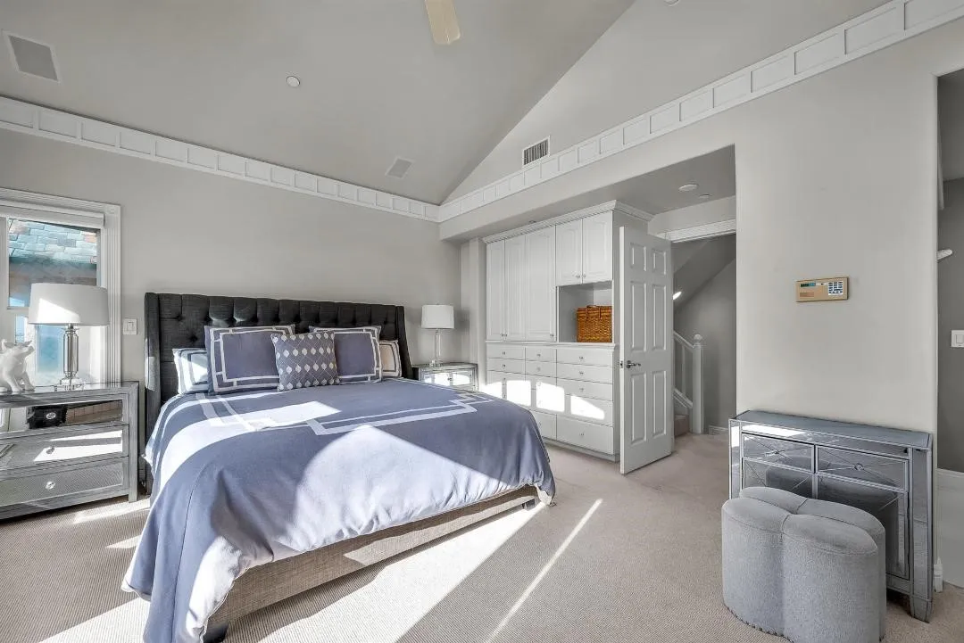 47 Surfside Avenue Surfside, CA 92649 - Photo 23 of 37 a bedroom with a large bed couch and windows