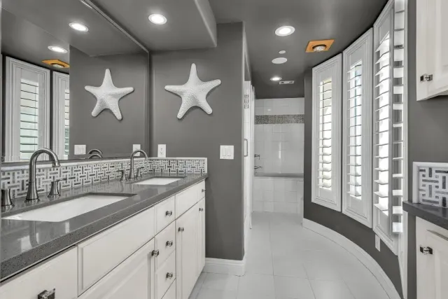 a bathroom with a double vanity sink and a mirror