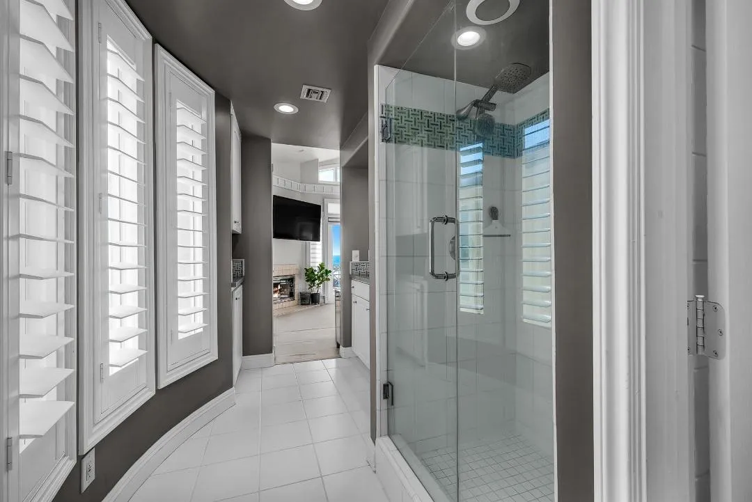 47 Surfside Avenue Surfside, CA 92649 - Photo 26 of 37 a bathroom with a glass shower door and a bathroom