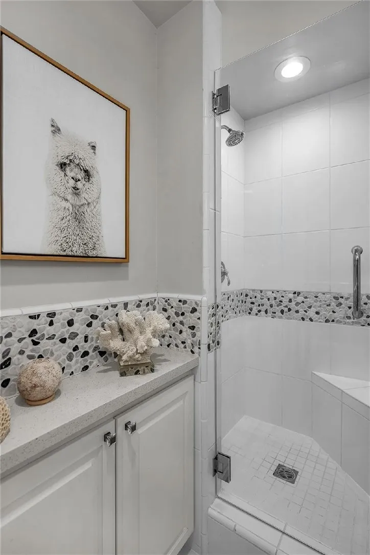 47 Surfside Avenue Surfside, CA 92649 - Photo 29 of 37 a bathroom with a bathtub and a shower