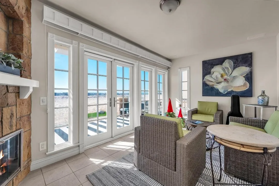 47 Surfside Avenue Surfside, CA 92649 - Photo 5 of 37 a living room with furniture a floor to ceiling window and a fireplace