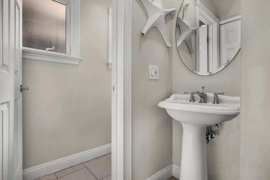 47 Surfside Avenue Surfside, CA 92649 - Photo 7 of 37 a bathroom with a sink and a mirror