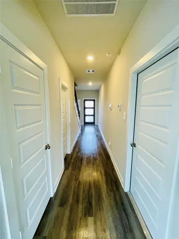 a view of gallery with wooden floor