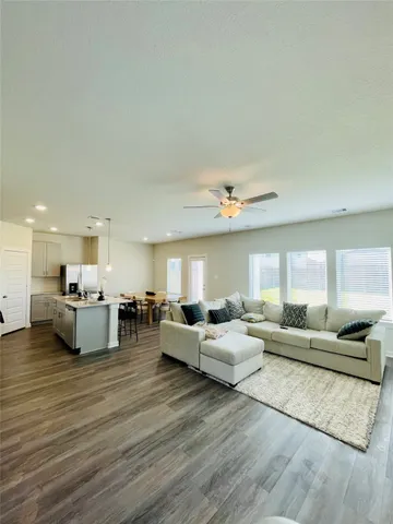 a living room with furniture and wooden floor